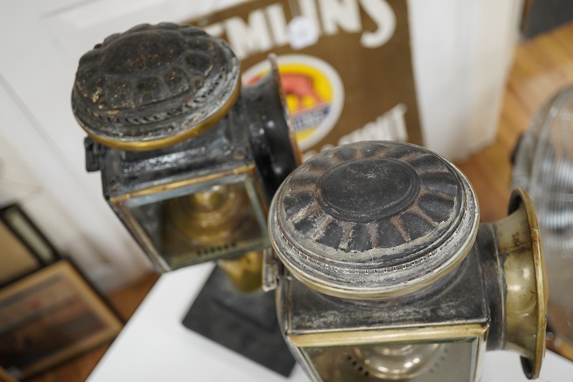 Two 19th century brass and painted steel carriage lamps, one by Raydyot with sprung ‘self adjusting’ candle holders, now mounted on modern painted pine bases for display purposes